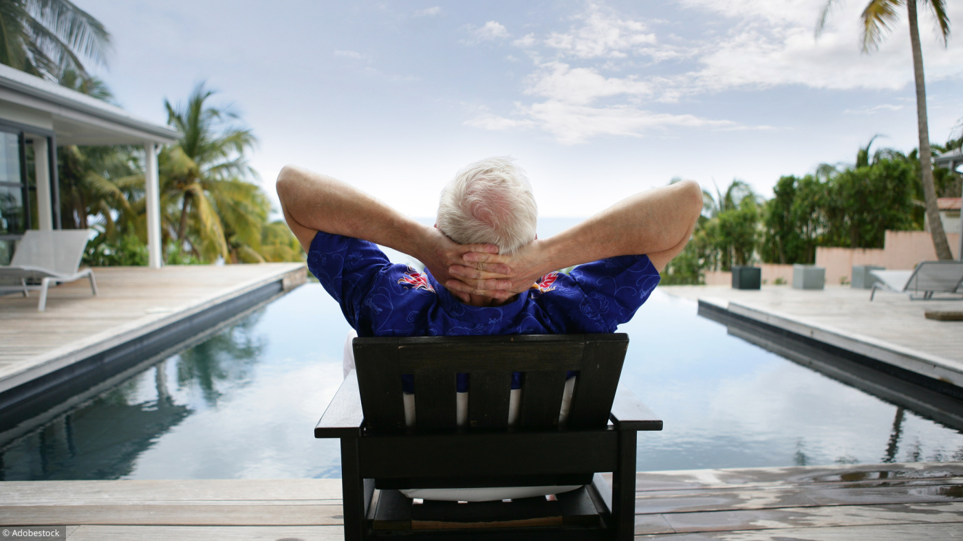Older man relaxing by a luxurious pool